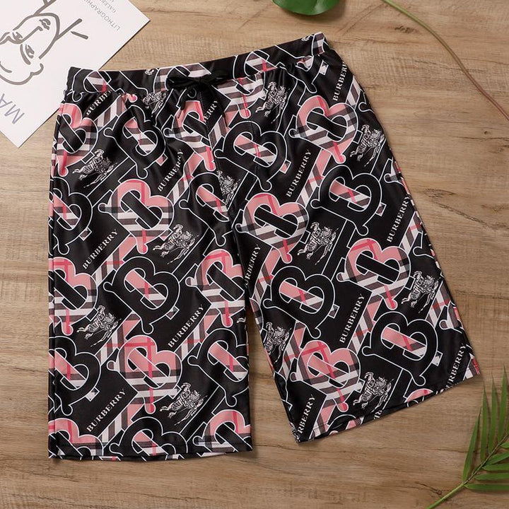 BURBERRY black shorts featuring a trendy logo print, perfect for casual, stylish summer wear.